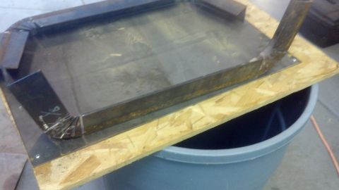 1995 Ford Bronco - Custom metal fabrication, possibly for a vehicle part, is shown mounted on a wooden base.