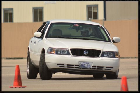 2000 Mercury Grand Marquis - White 2000 Mercury Grand Marquis captured from the front, navigating a course with orange cones.