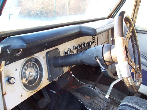 1969 Ford Bronco - The interior of a 1969 Ford Bronco shows the dashboard with its distinctive round speedometer and a three-spoke steering wheel.