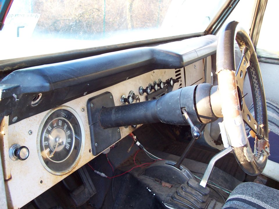 1969 Ford Bronco interior dashboard with round speedometer and steering wheel
