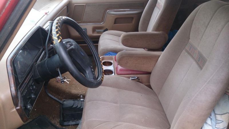 Interior view of a vehicle's driver and passenger seats, dashboard, and steering wheel