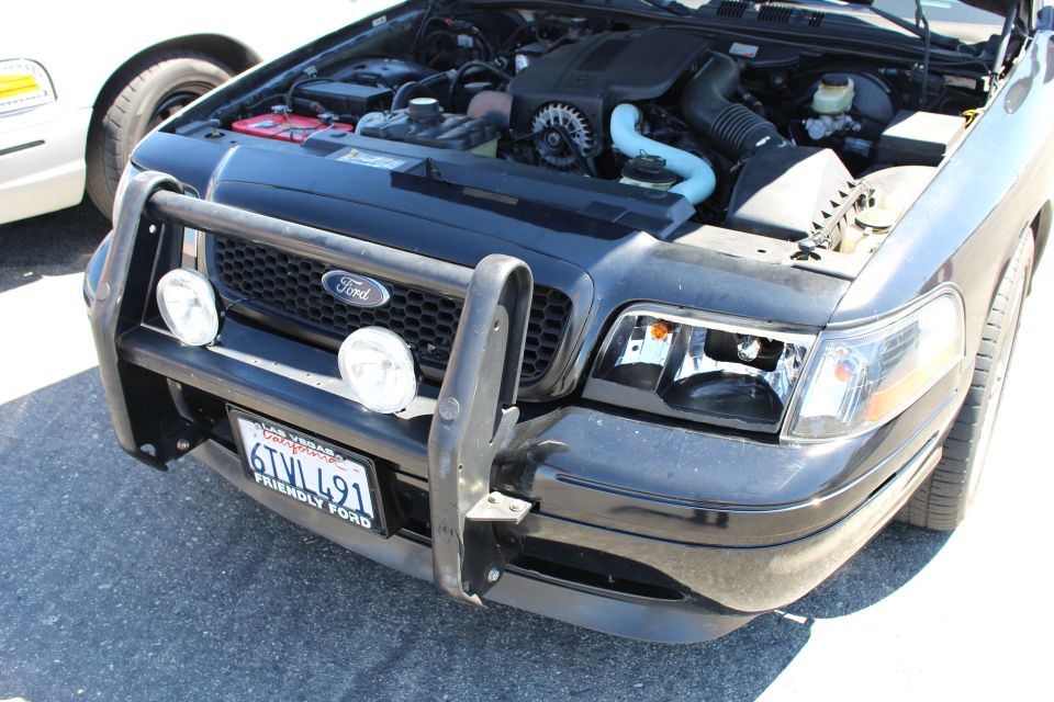 Black Ford Crown Victoria front, hood up, push bar with dual spotlights