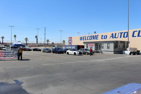 2003 Ford Crown Victoria - Cars stage in a wide lot near the 'AUTO CLUB' building, with a Lucas Oil banner and a School of Automotive Machinists sign.
