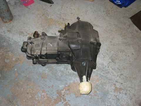 1993 Ford F-150 - A transmission unit with "8DA" visible on its casing rests on a concrete floor.