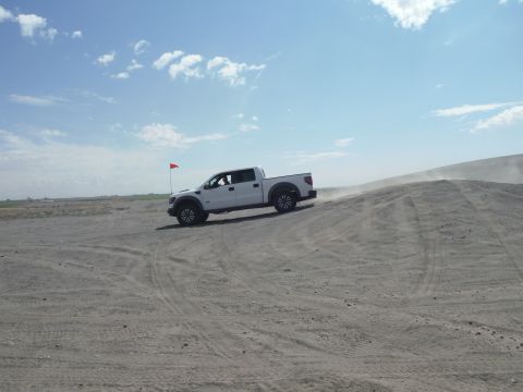 2005 Jeep Wrangler - Pickup truck navigates sandy terrain with a red flag marking the location.