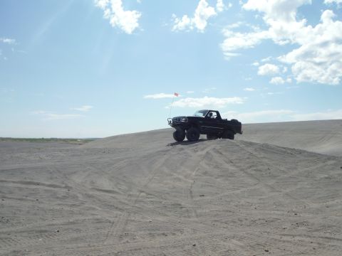 2005 Jeep Wrangler - Pickup truck parked on a sand dune with a small flag attached to the antenna.