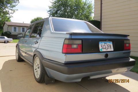 1990 Volkswagen Jetta - A 1990 Volkswagen Jetta is parked in a driveway on a sunny day.