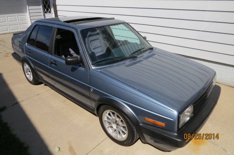 1990 Volkswagen Jetta - Blue 1990 Volkswagen Jetta sedan with a sunroof and aftermarket wheels.