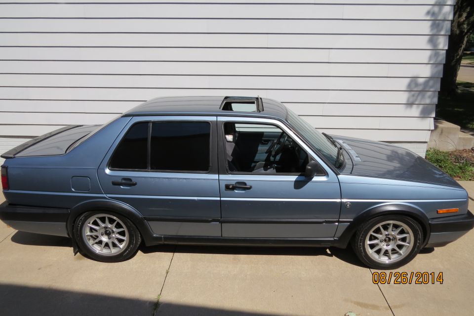Side view of a blue 1990 Volkswagen Jetta with a sunroof