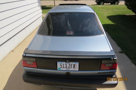 1990 Volkswagen Jetta - Rear view of a 1990 Volkswagen Jetta, showing its distinctive taillights and spoiler.