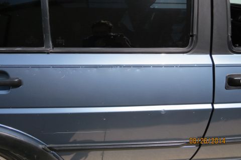 1990 Volkswagen Jetta - This vehicle has a pinstripe along the side and a reflection in the window.