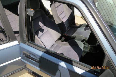 1990 Volkswagen Jetta - Interior view of a light blue 1990 Volkswagen Jetta, showing the front seats and manual shifter.