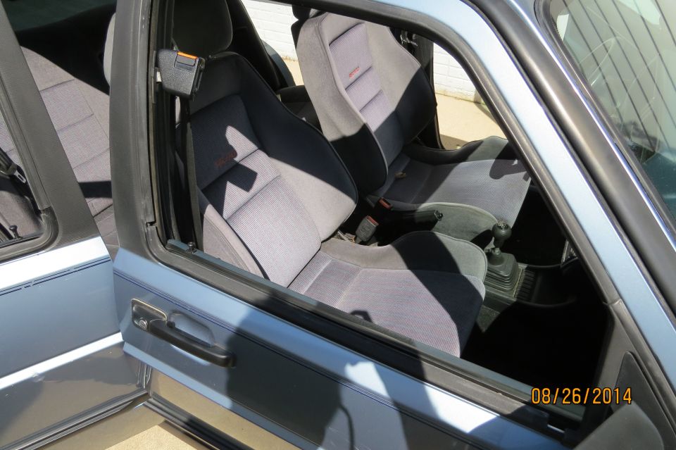 Light blue 1990 Volkswagen Jetta interior with grey cloth seats and a manual transmission
