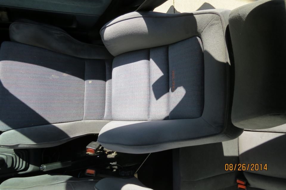 Gray fabric car seats with orange stitching detail