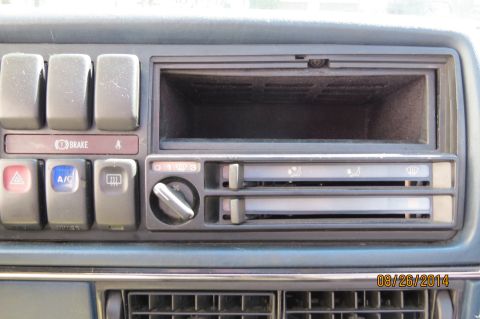 1990 Volkswagen Jetta - The dashboard features several buttons and climate controls, along with an empty slot for a radio or other device.