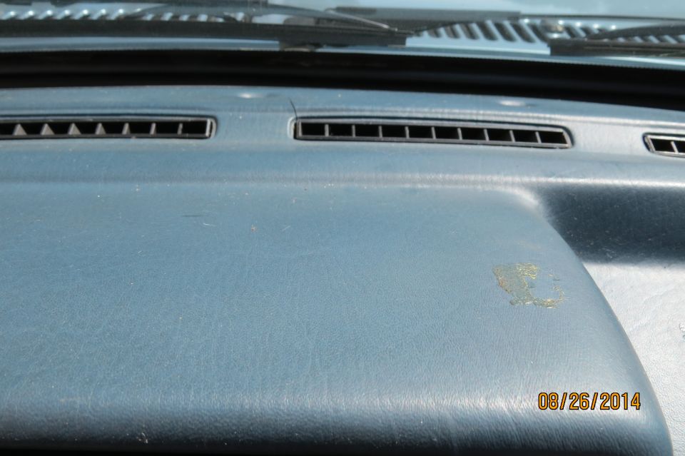 Dashboard interior with air vents and a date stamp