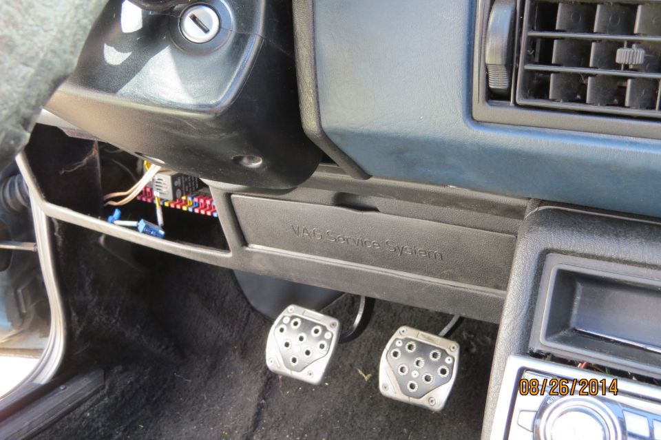 Volkswagen Jetta interior showing fuse box, pedals, and VAG Service System compartment