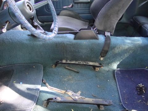 1972 Ford Pinto - The interior of a car, with the floor carpet and seats visible, along with removed seat rails.