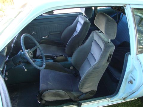1972 Ford Pinto - Interior view of a 1972 Ford Pinto, highlighting the front seats and dashboard area.