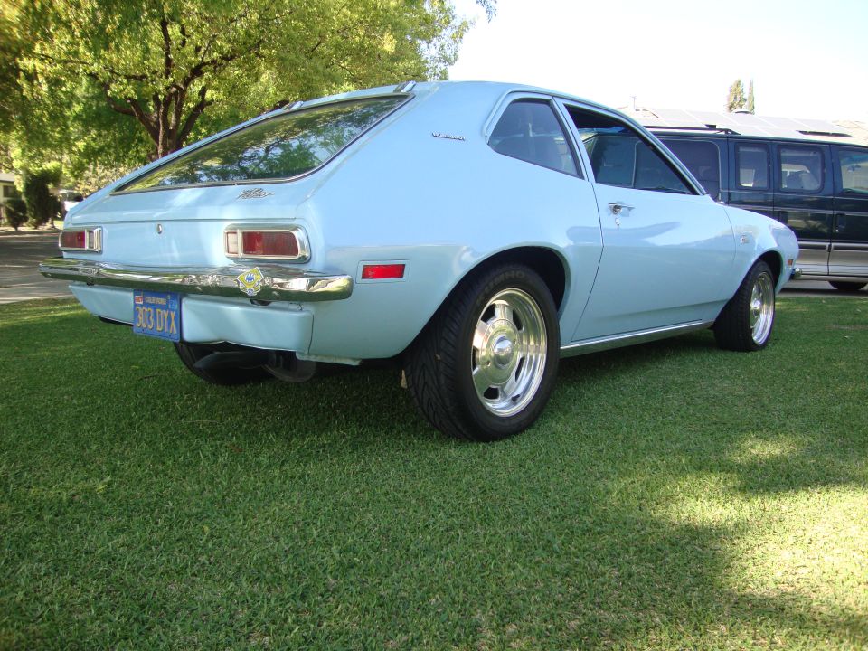 Light blue 1972 Ford Pinto hatchback with chrome wheels and a California license plate