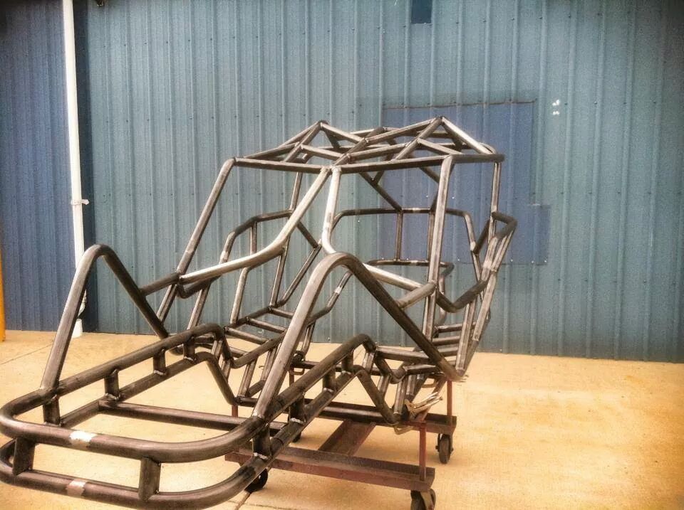 Custom tube chassis frame on a rolling stand, unfinished