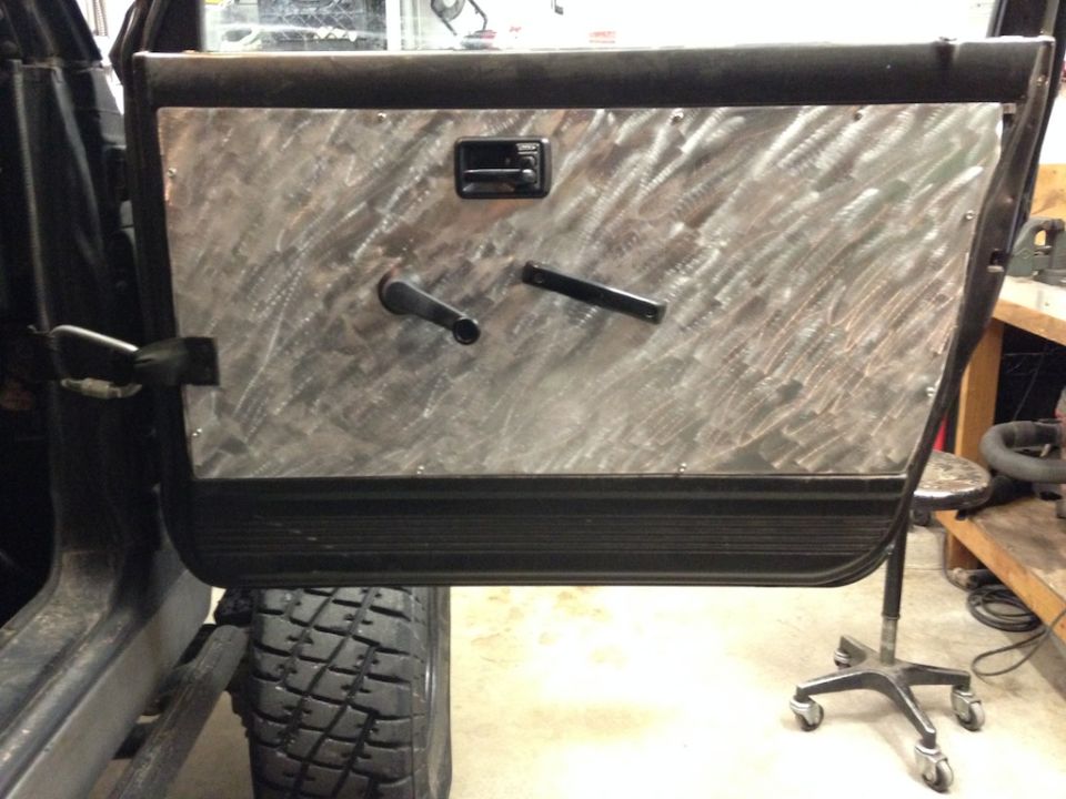 Custom aluminum door panel with manual window crank and lock knob