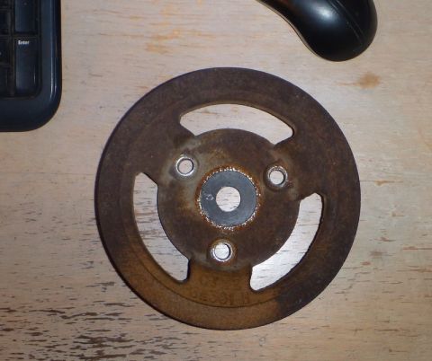 1964 Mercury Monterey - A rusty pulley is shown on a wooden surface, with a keyboard and mouse nearby.