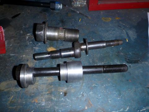1964 Mercury Monterey - Various metal suspension parts are laid out on a workbench.