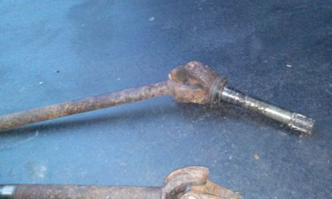 1994 Ford Bronco - Close-up of a rusty drive shaft component, likely for a vehicle's drivetrain.