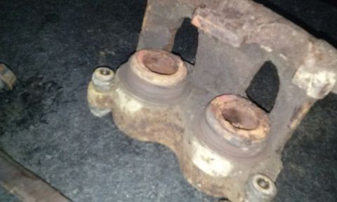 1994 Ford Bronco - This is a close-up view of a rusty brake caliper, likely for sale as a part.