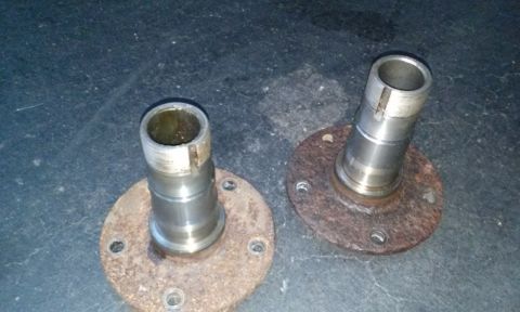 1994 Ford Bronco - Two vehicle wheel hubs are shown, each with a rusty mounting flange and a metal shaft.