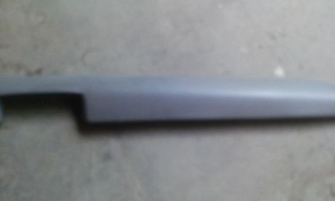 1994 Ford Bronco - Gray plastic trim piece with a cutout on the left side.