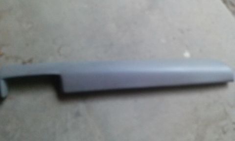 1994 Ford Bronco - A gray plastic trim piece is shown against a concrete surface. The 'Supermotors' logo is visible in the bottom right corner.