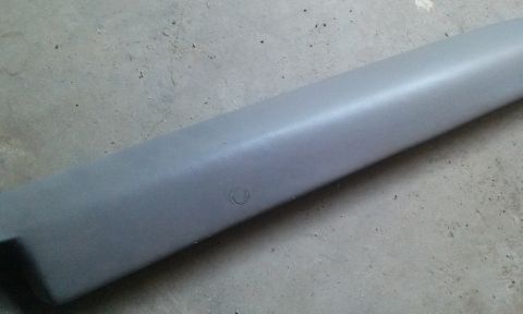 1994 Ford Bronco - A gray plastic trim piece is shown against a concrete background, with a watermark at the bottom right.