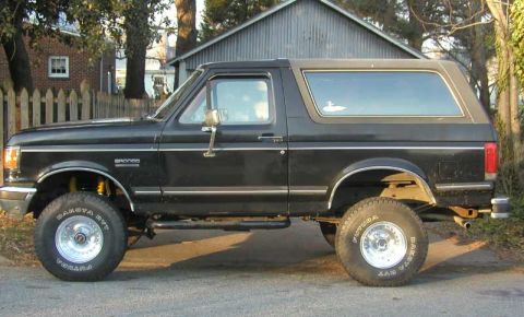 1988 Ford Bronco - This 1988 Ford Bronco is shown in profile, aftermarket wheels and a lifted suspension.