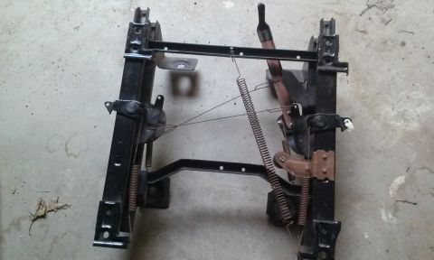 1994 Ford Bronco - This is a vehicle seat frame, likely for the driver's side, with visible springs and adjustment mechanisms.