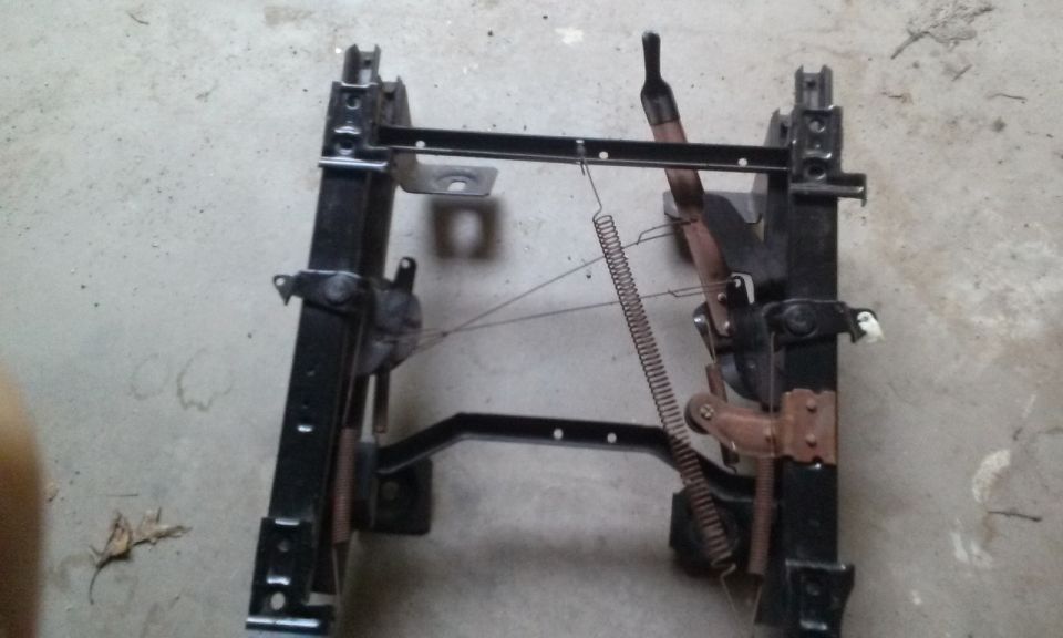 Seat frame with springs and levers, viewed from the side