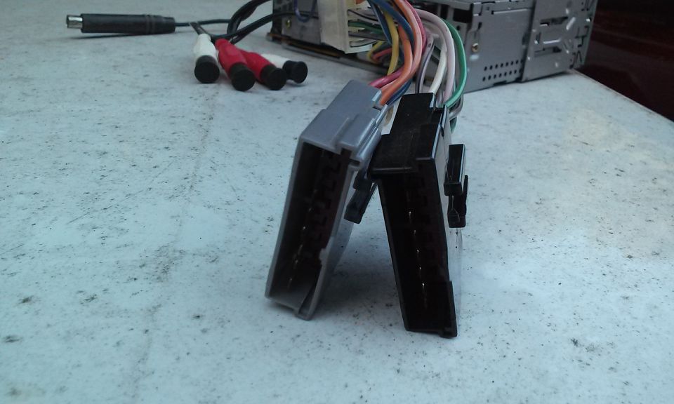 Car stereo wiring harness with RCA connectors and a power adapter