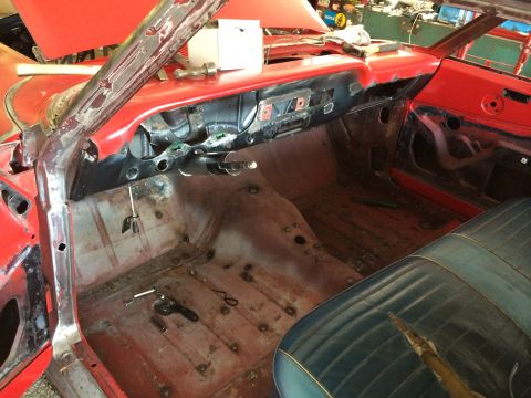1964 Ford Fairlane - The interior of a 1964 Ford Fairlane shows extensive bodywork and rust on the floor pans, with the dashboard removed.