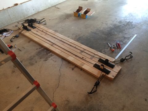1989 Ford Bronco - Wooden plank assembly with straps and hardware, likely for a DIY project or repair.