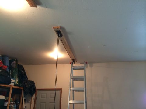 1989 Ford Bronco - A homemade hoist system is mounted to the garage ceiling, with a ladder nearby.