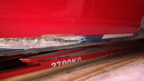1994 Ford Thunderbird - This vehicle's rocker panel has visible damage and rust, indicating it may have been involved in an accident.