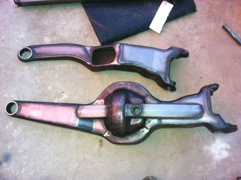1995 Ford Bronco - Automotive differential housings and axle components are shown on a concrete surface.