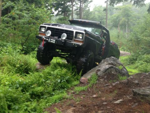 1979 Ford Bronco - This modified 1979 Ford Bronco navigates a challenging off-road course with large tires and a lifted suspension.