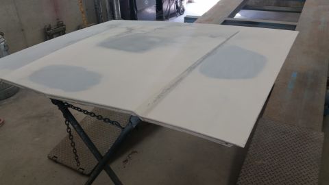 1991 Ford LTD Crown Victoria - A car hood is prepped with body filler in preparation for painting.
