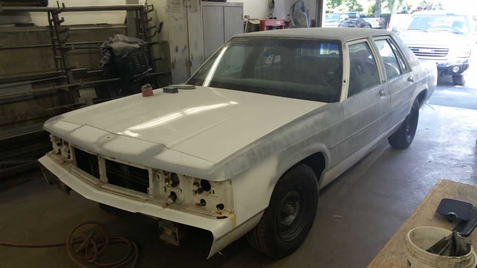 1991 Ford Crown Victoria LTD in primer, front end disassembled, in a workshop