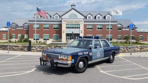 1991 Ford LTD Crown Victoria - Rhode Island State Police Crown Victoria, marked 'STATE POLICE 90E', parked outside the Public Safety Complex.