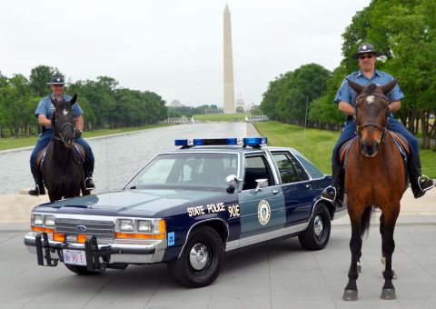 1991 Ford LTD Crown Victoria - Two-tone blue Ford LTD Crown Victoria marked 'STATE POLICE 90E' with a Massachusetts state seal decal, push bumper, blue lightbar and Massa…