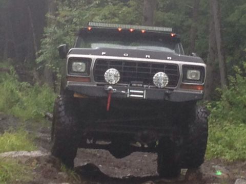 1979 Ford Bronco - This 1979 Ford Bronco is shown from the front while navigating a rough, wooded trail.