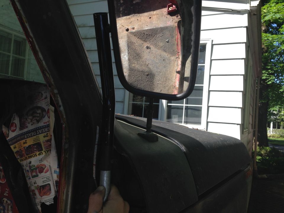 Side mirror assembly and interior door panel with newspaper lining